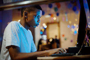 a teen in need of gaming addiction treatment uses a computer