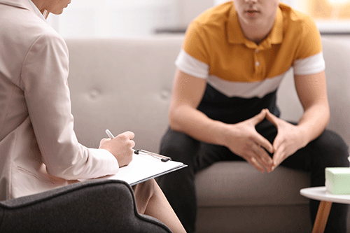 a teen listens while a therapist talks