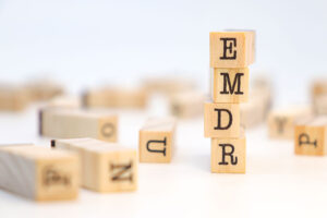 blocks stack and spell "EMDR" to represent an emdr therapy program 