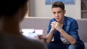 a teen listens to a therapist during rational emotive behavior therapy 