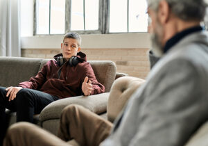a teen boy talks to a therapist in a relapse prevention therapy program