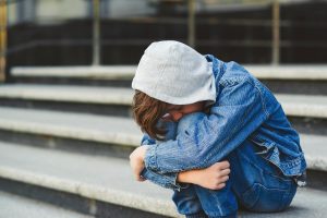 Person struggling with depression and teen substance use