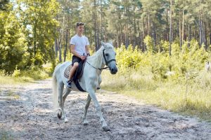 Teen learning how equine therapy works