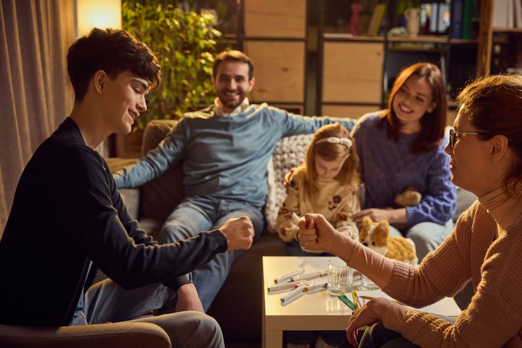 a family plays a board game together after learning about family systems theory