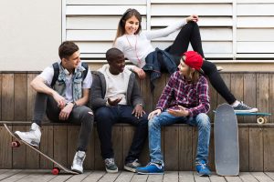 a group of teens works on social skills training for autism