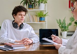 a teen listens to a therapist during Adolescent OCD Treatment 