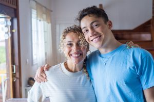 a teen and mom smile after learning how to control impulsive behavior