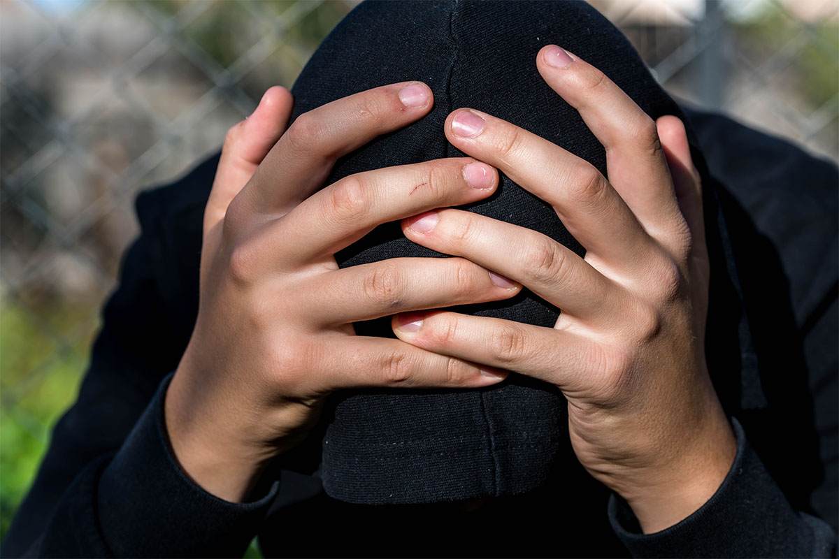 a teen holds his head after receiving a dmdd diagnosis