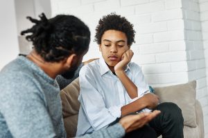 a father talks to his son after learning more about parenting a child with dmdd