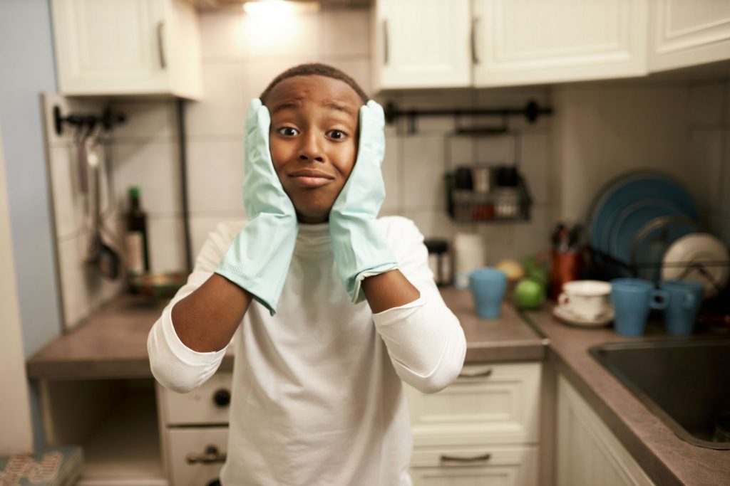 a teen wears gloves and holds their face after confronting a common ocd trigger