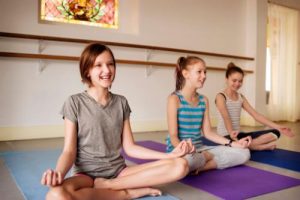 teens do yoga during holistic therapy