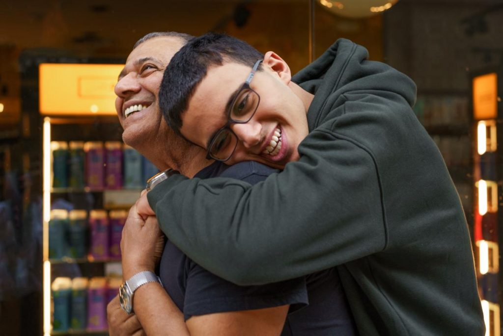 a teen hugs their parent after trauma-informed care