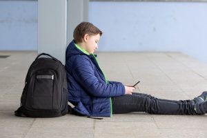 a teen uses their phone to research "what are neurodevelopmental disorders?"