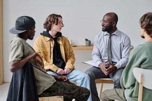 an adolescent therapy group for boys meets for a session in treatment 