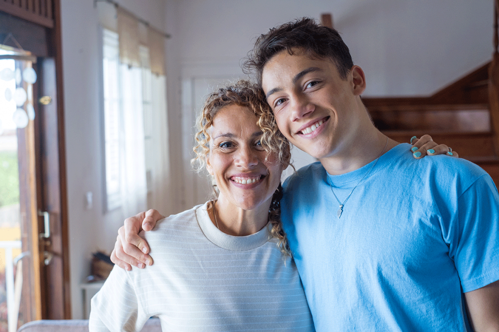 a mother and son smile after learning about the importance of family engagement in recovery