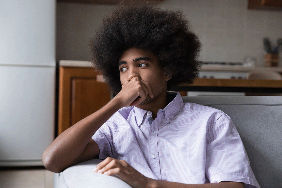 a boy looks anxious, one of the signs of ptsd in teens