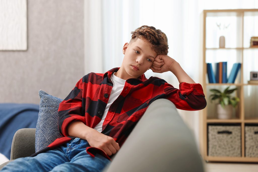 a teen sits on a couch thinking about his treatment plan for anxiety