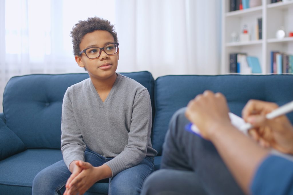 Teen boy speaking to psychiatrist