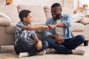 a son and father fist bump after learning why family is important