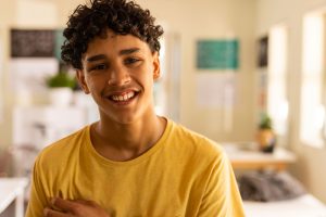 a teen smiles after safe and sound protocol therapy